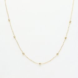 Delikatny złoty naszyjnik z koralikami – minimalistyczna elegancja na co dzień